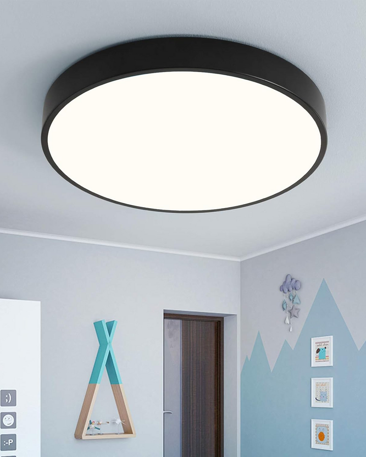 Black flush mount ceiling lamp lighting a modern children bedroom