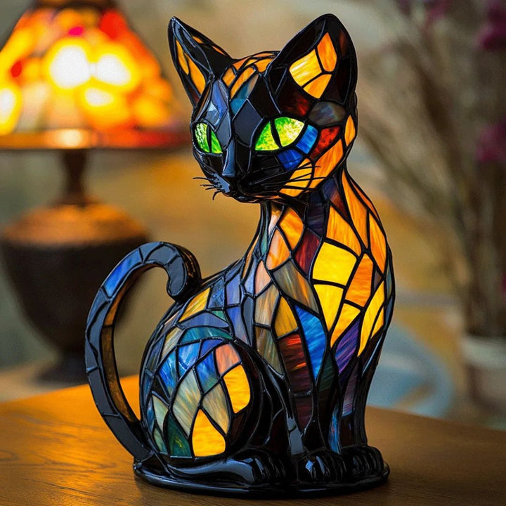 Decorative mosaic cat-shaped table lamp glowing warmly on a wooden surface
