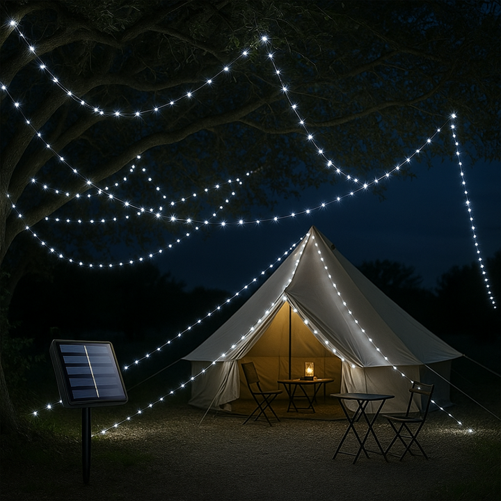 White LED solar string lights glowing outdoors over a camping tent at night