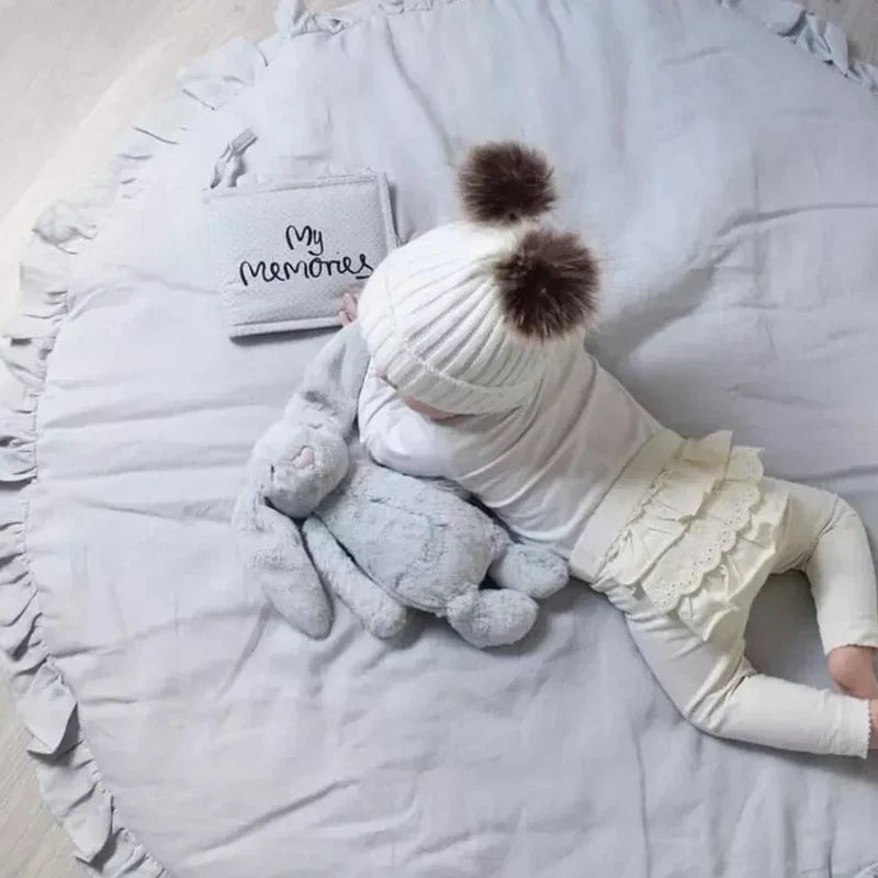 Soft round baby play mat in neutral gray for nursery room decor
