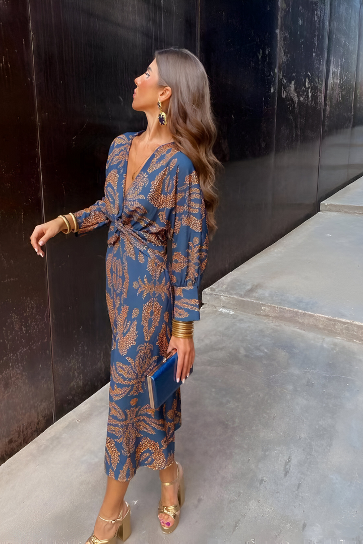 Woman wearing blue floral midi dress with twist-front detail