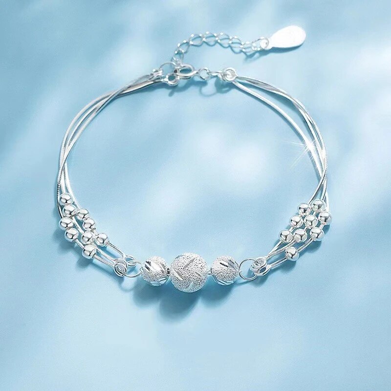 Sterling silver multi-strand bracelet featuring textured spherical beads