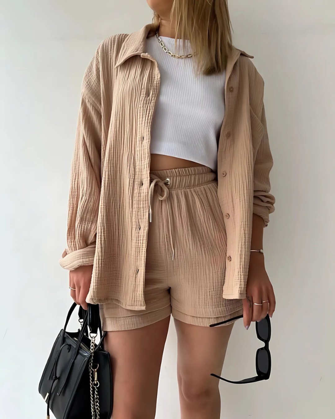 Woman wearing khaki two-piece short set with button-down shirt and matching shorts