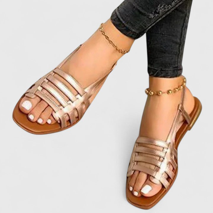 Women wearing gold orthopedic slingback sandals with strap design