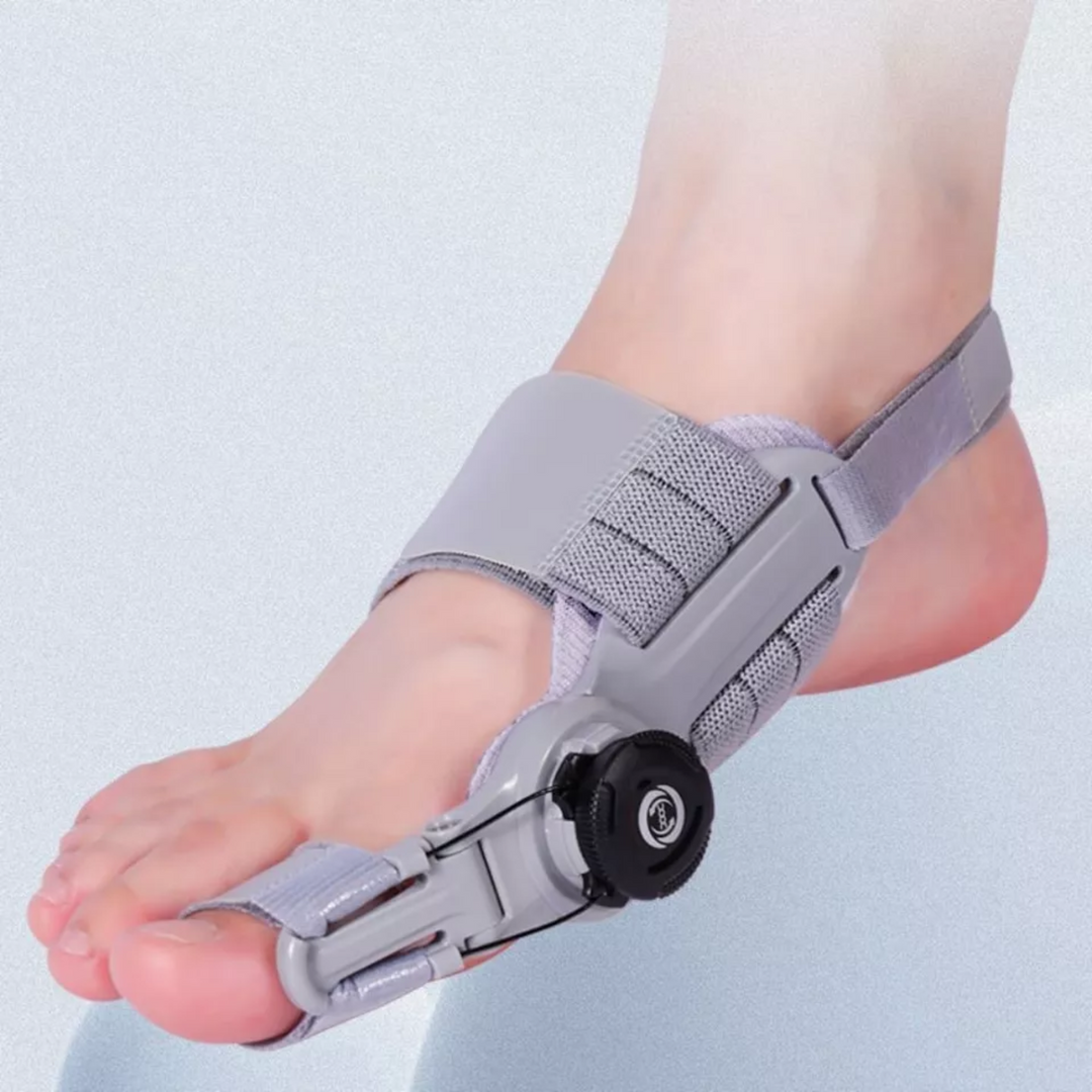 Orthopaedic toe bunion corrector worn on foot showing strap and knob mechanism