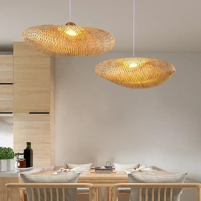 Handmade rattan pendant lamps hanging above a wooden dining table in a modern interior