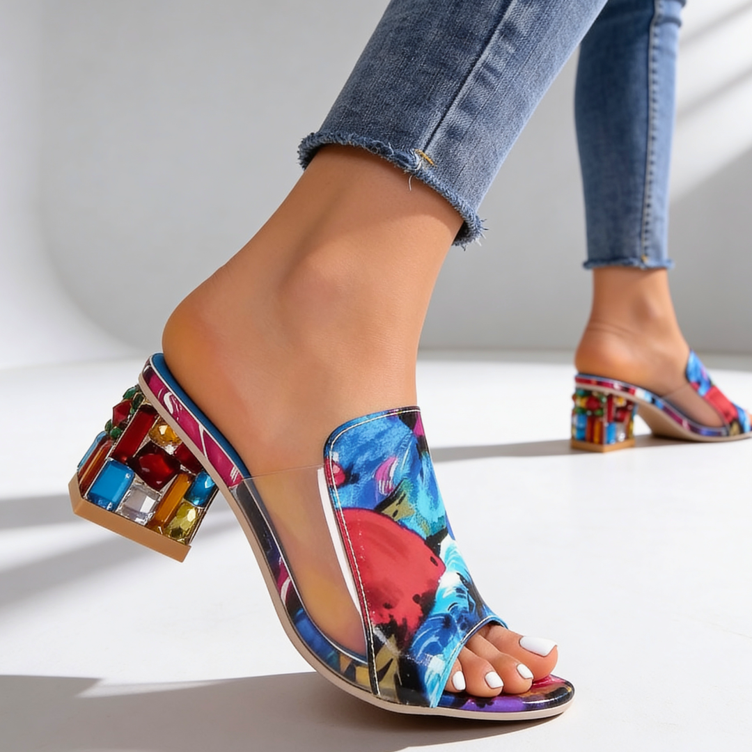Detailed view of floral print rhinestone block heel slide sandal on foot
