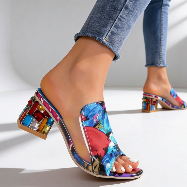 Detailed view of floral print rhinestone block heel slide sandal on foot
