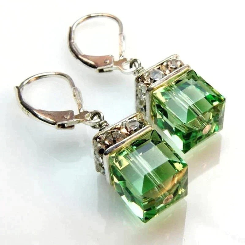 Close-up of green peridot drop earrings with square crystals