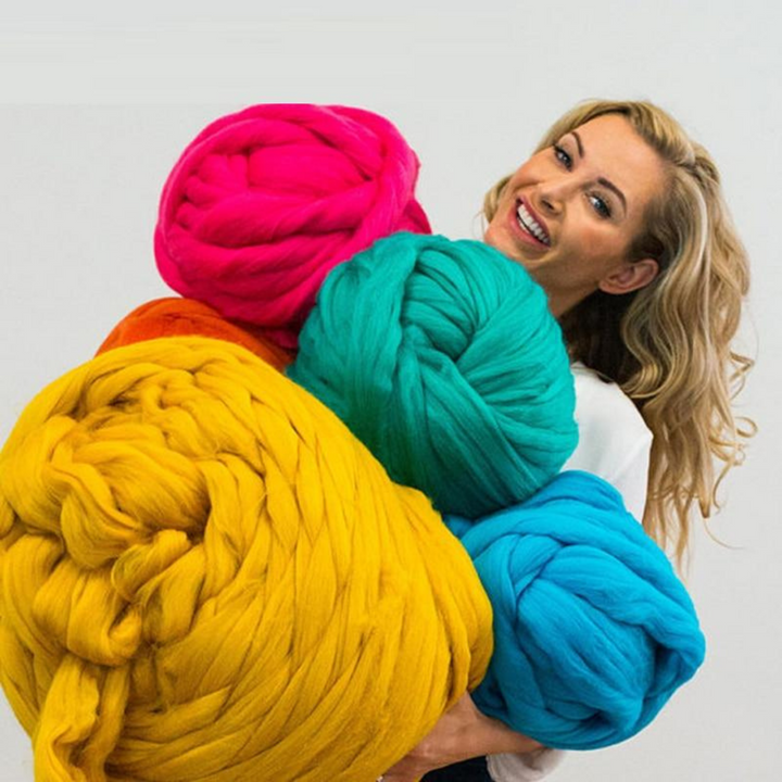Close up of thick yarn skeins included in the handmade cozy throw kit