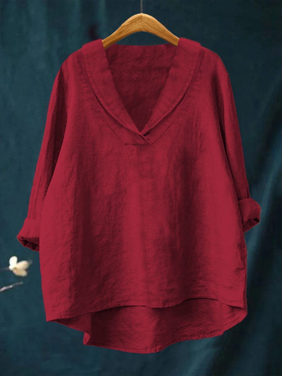 Red women's timeless blouse hanging on wooden hanger