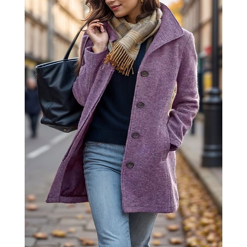 Woman wearing a purple turn-down collar trench coat outdoors with a scarf and handbag