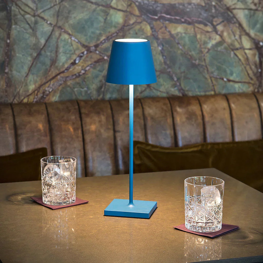 Matte Blue cordless rechargeable LED table lamp resting on a restaurant table