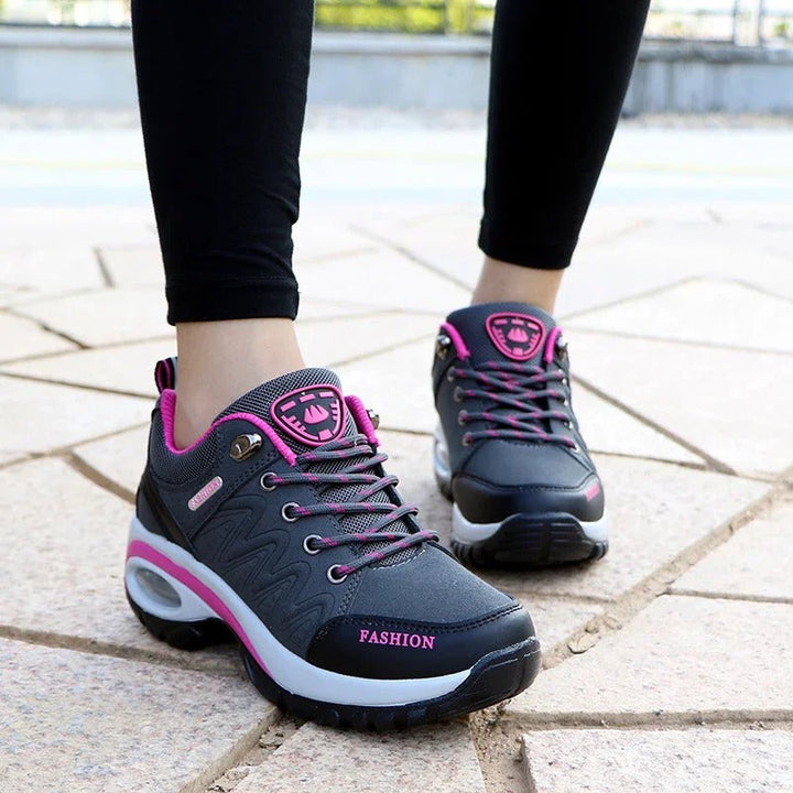 Side view of pink women's orthopedic walking sneakers showing tread