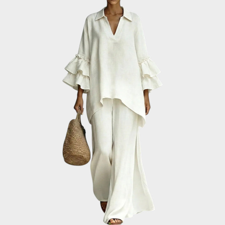 Model wearing white ruffle sleeve two piece matching set with wide-leg pants