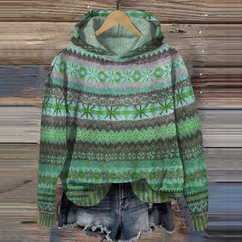 Women's green vintage Fair Isle hooded sweater on a wooden background