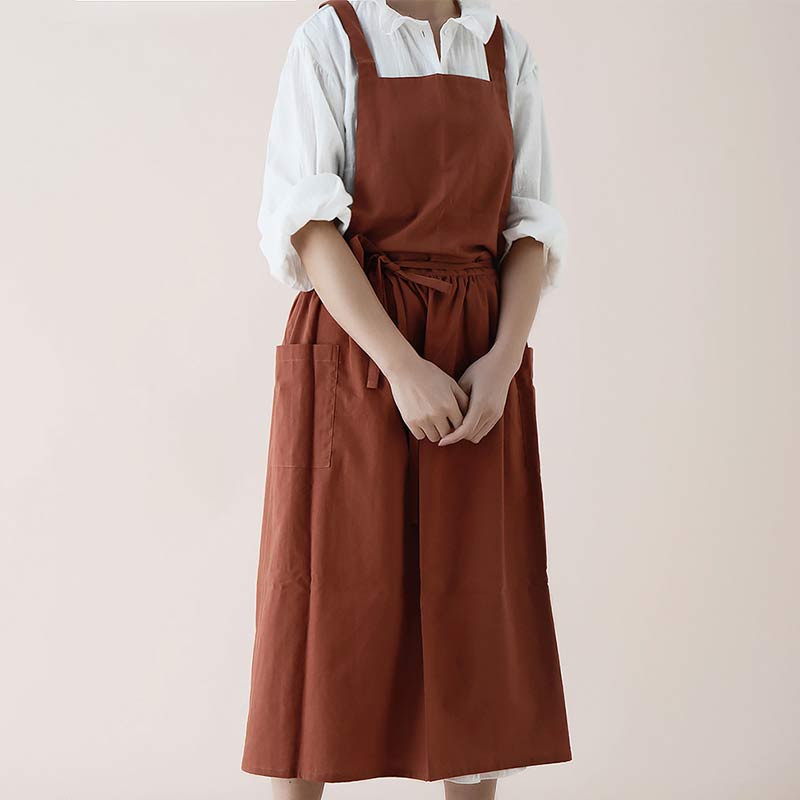 Unisex pink kitchen apron folded neatly to display compact storage