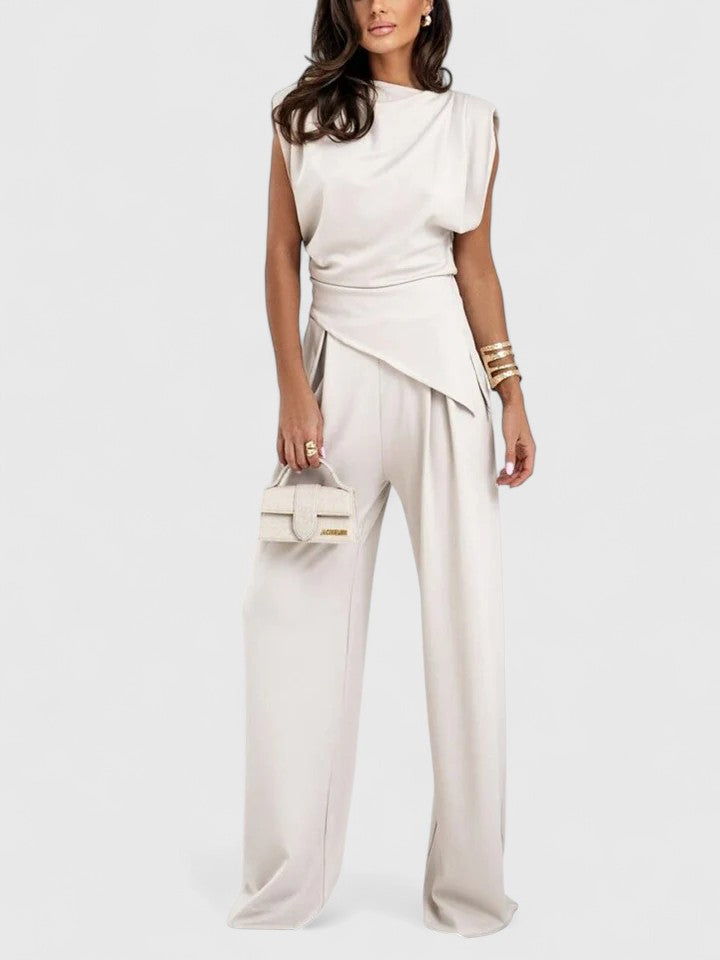 Woman wearing beige draped sleeveless top and wide leg trousers set