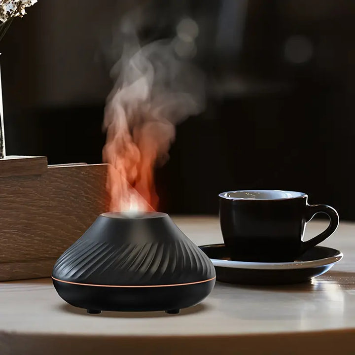 Black LumoMist diffuser resting on a desk beside a coffee cup