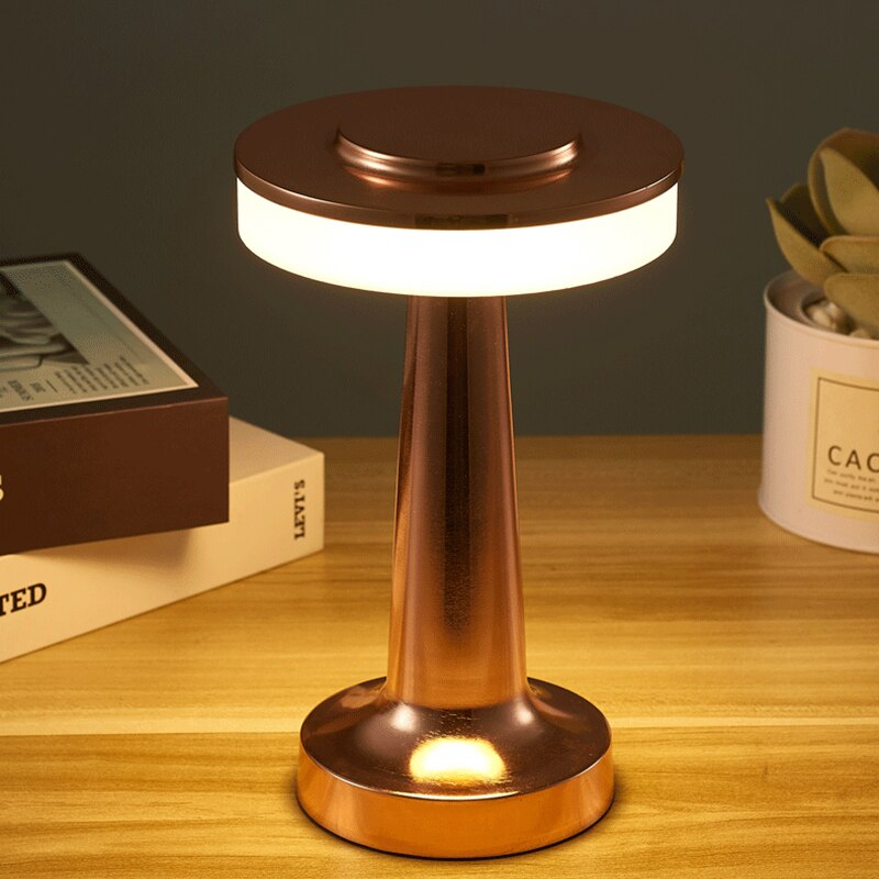 Rechargeable cordless table lamp casting warm ambient lighting on a modern desk