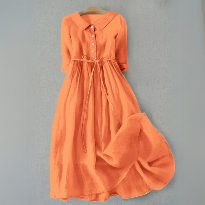 Vibrant orange button-front tie waist flowy midi dress displayed on a hanger
