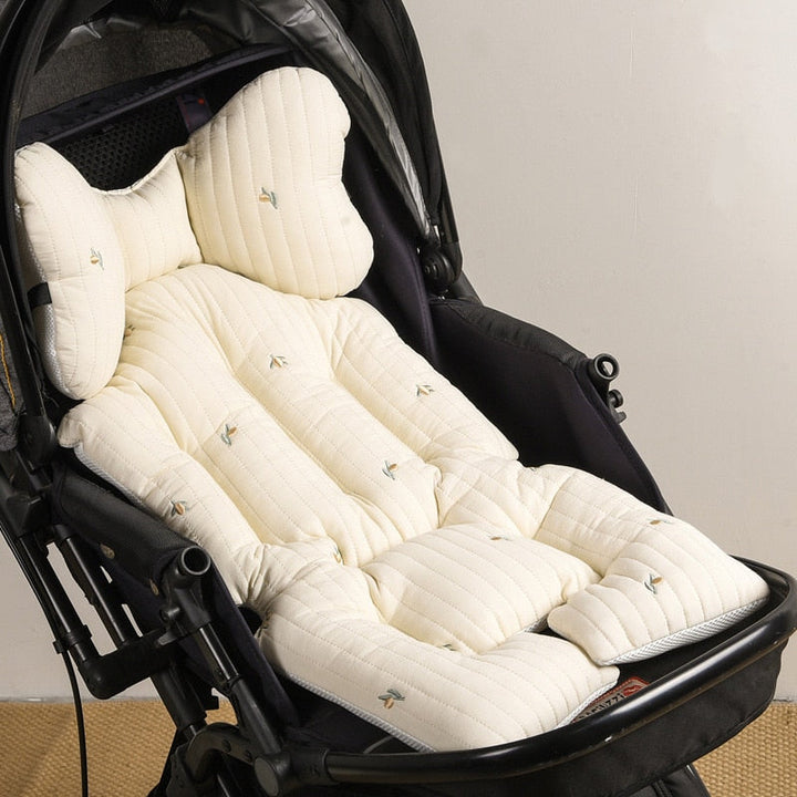 Reversible stroller cushion featuring playful animal pattern and soft padding