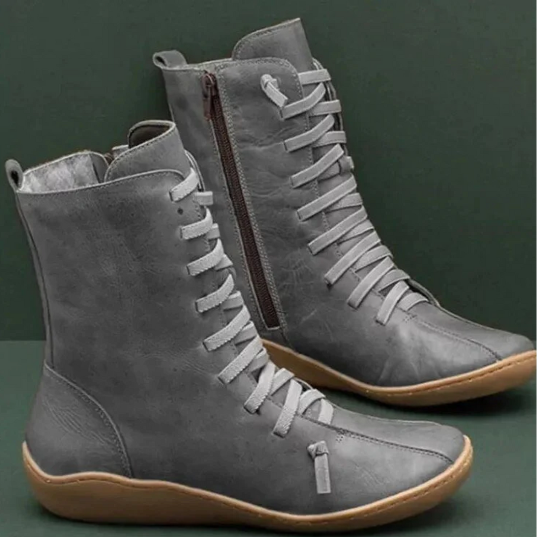 Grey women's waterproof winter boots displayed on a dark surface