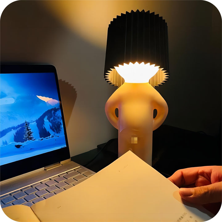 Cordless playful LED lamp casting warm ambient light on a modern wooden desk surface.