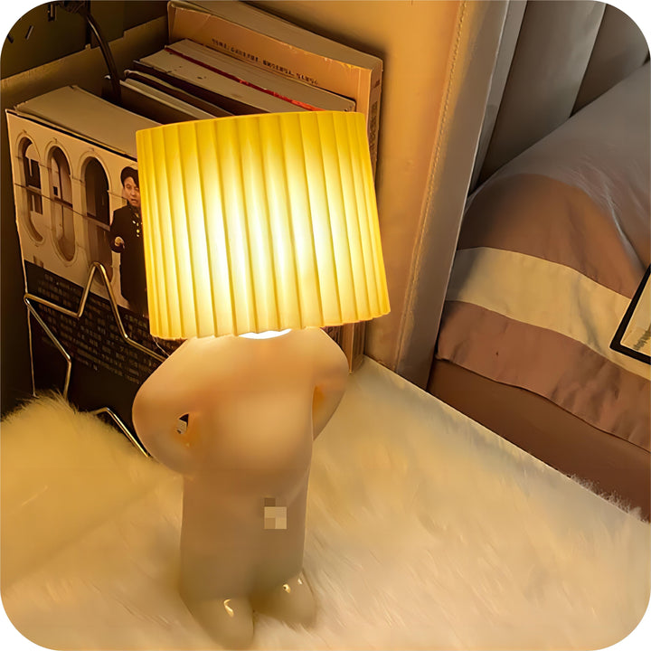Quirky rechargeable night light styled on a bedside table with books and plants.