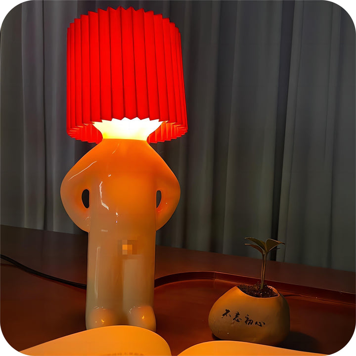 Red cordless whimsical LED lamp glowing on a desk