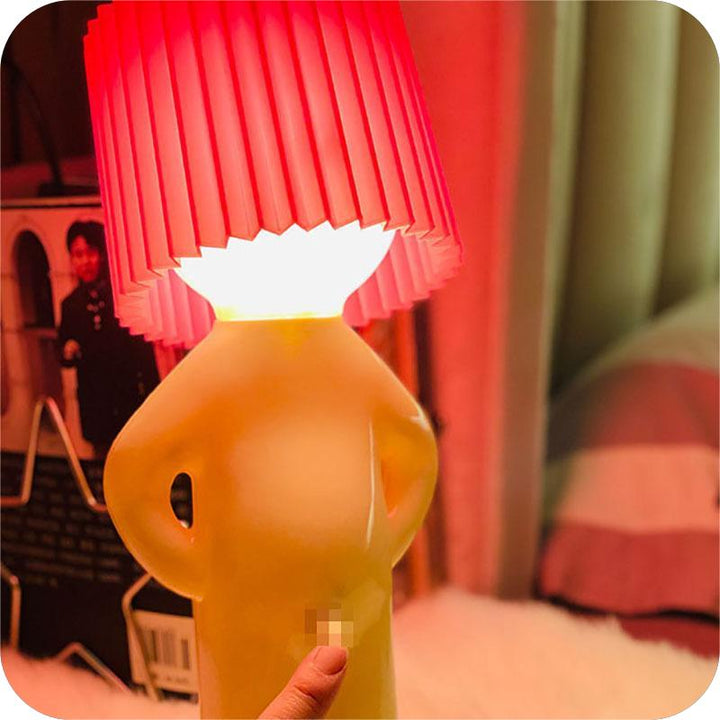 Stylish desk light placed on a bookshelf, highlighting playful home decor aesthetics.