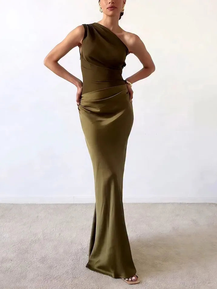 Woman wearing dark green one-shoulder pleated maxi dress posing