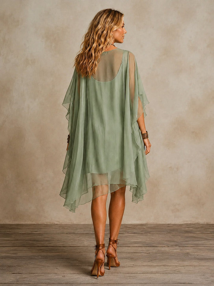 Side view of the green casual summer mini dress showing its lightweight and breezy fabric