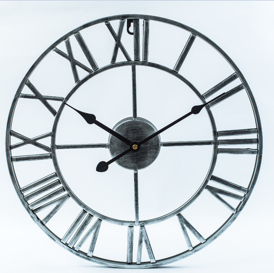 Angle view of oversized metal retro clock displaying antique design features