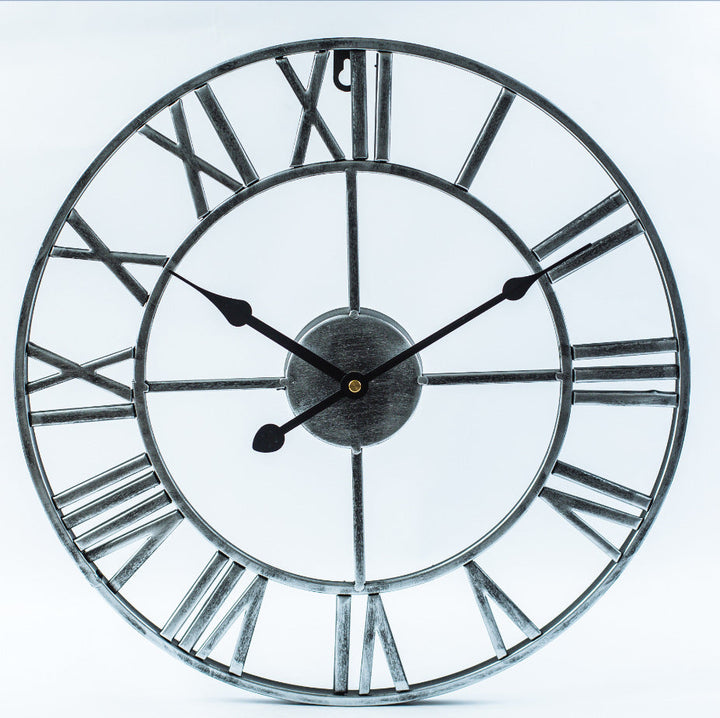 Angle view of oversized metal retro clock displaying antique design features