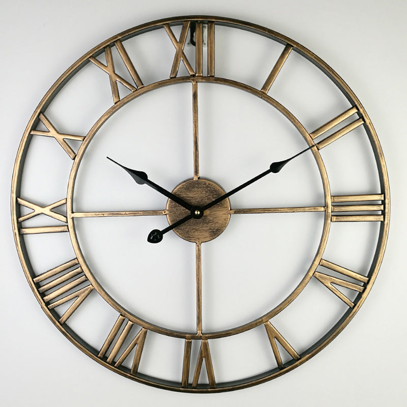 Large retro iron wall clock hanging on a white wall