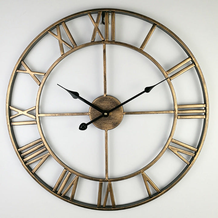 Large retro iron wall clock hanging on a white wall