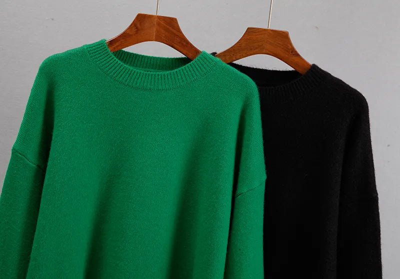 Model wearing the green oversized knit pullover with casual winter trousers