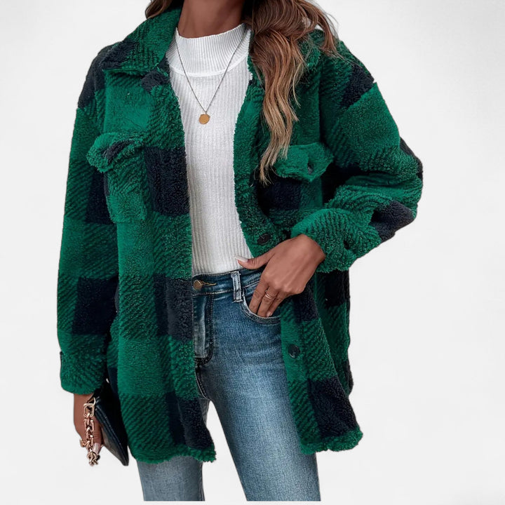 Close-up detail of fabric, buttons, and collar on a women's winter plaid shacket outerwear
