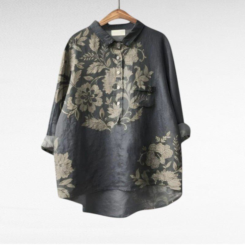 Women's dark gray floral summer blouse hanging on a wooden hanger