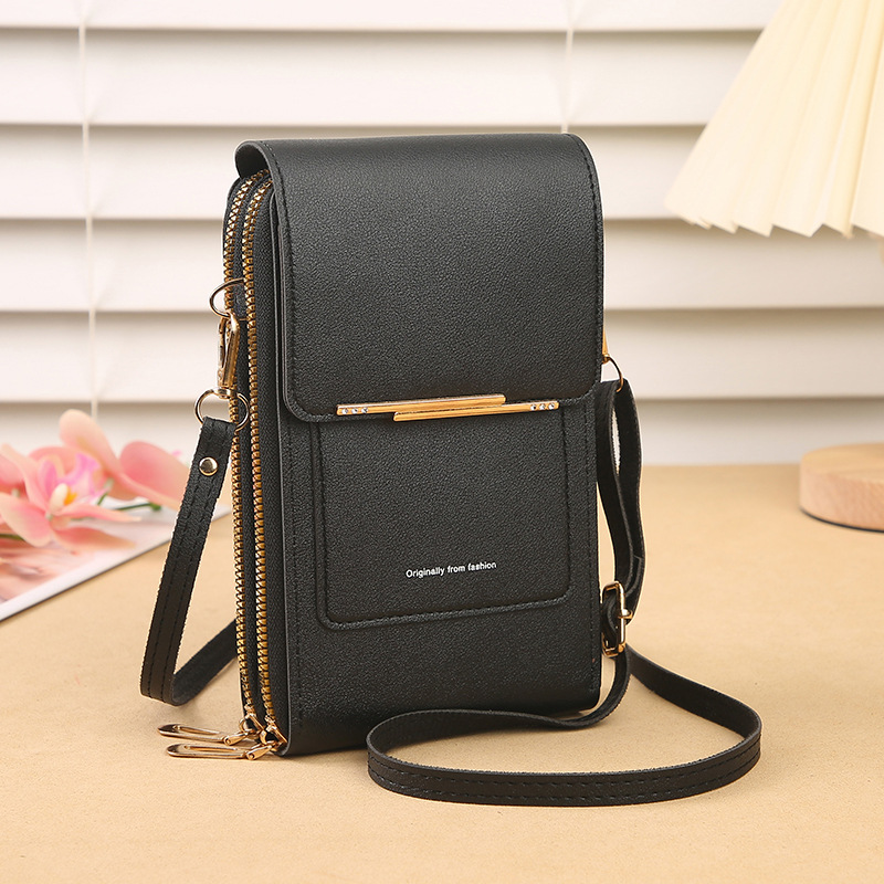 Womens travel purse hanging on hook displaying minimalist design and leather texture