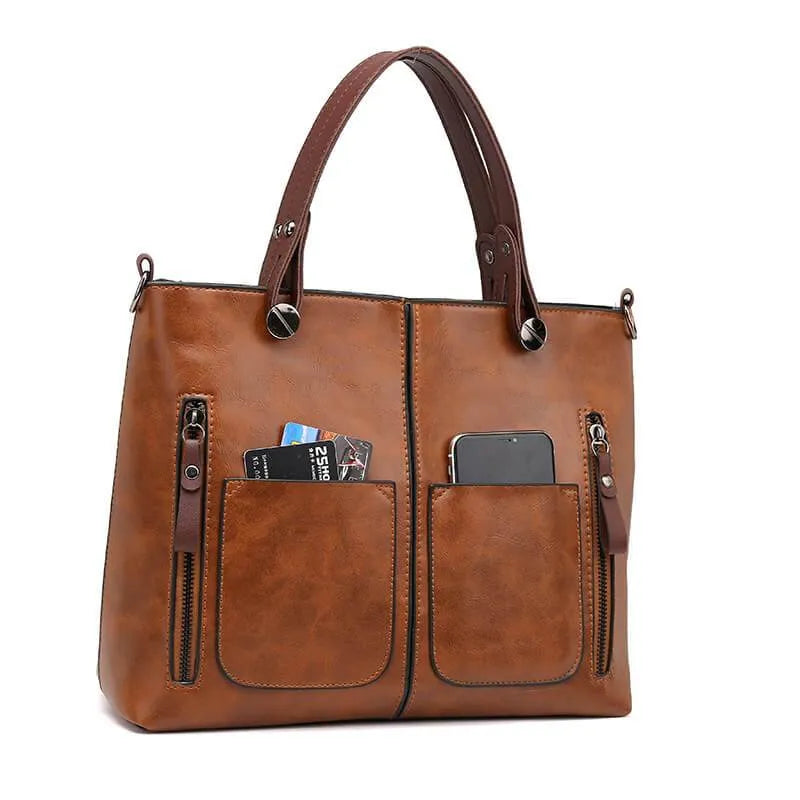 Close-up of durable metal hardware and zipper pull on a stylish women's work bag