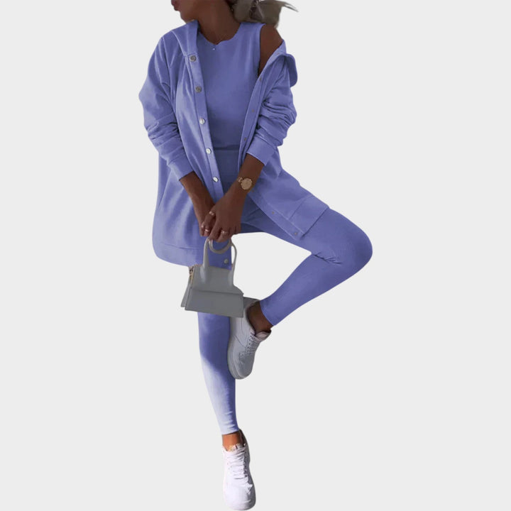 Woman wearing a purple three-piece lounge set featuring a hooded cardigan and tank top