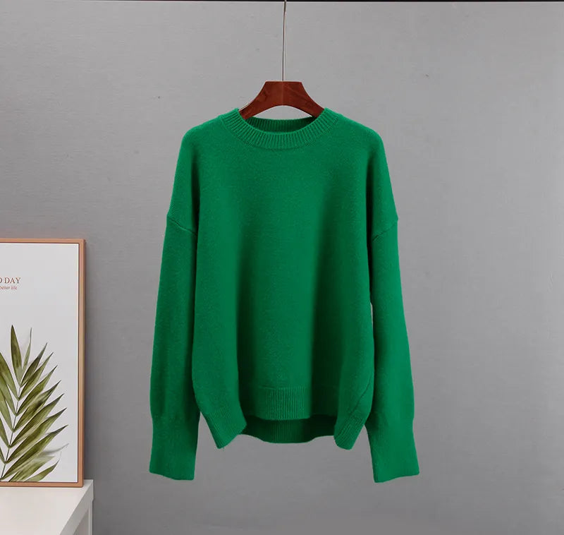 Close-up of the hemline and soft fabric texture on the green jumper