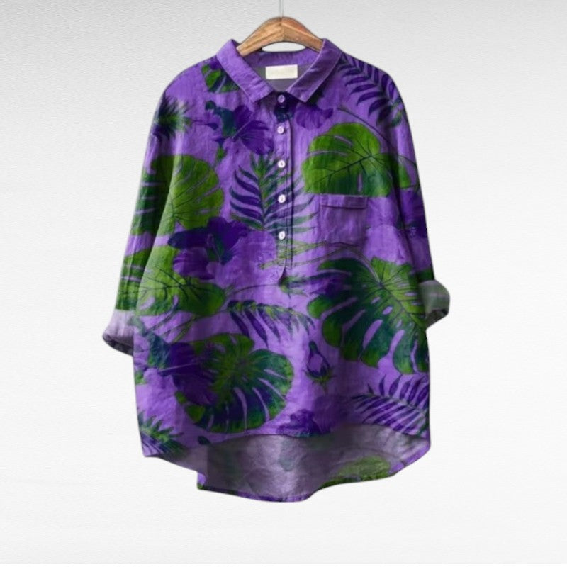 Women's violet floral summer blouse hanging on a wooden hanger