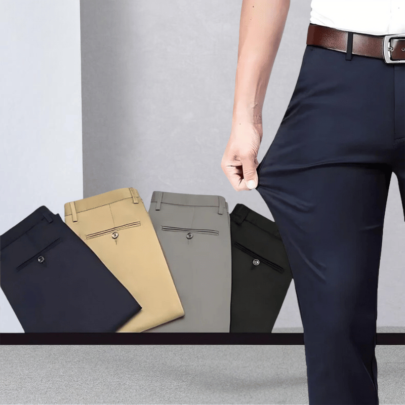Man demonstrating the flexibility of dark blue stretch trousers with folded colour options displayed in the background.