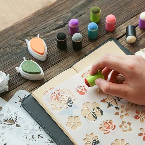 Kids stamp and ink pad art set laid out on a wooden table with colorful stamps