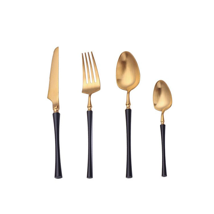 Matte gold and black stainless steel cutlery set displayed on a white background