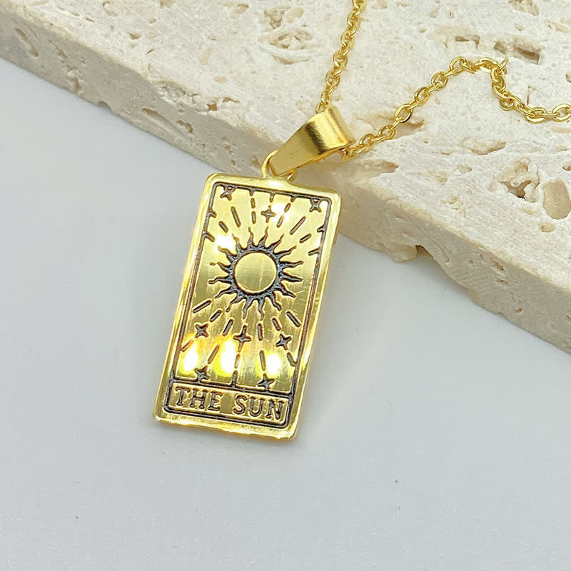 Gold pendant necklace with engraved tarot card luck charm motif