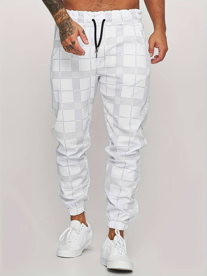 Close-up view of the breathable fabric and plaid pattern on men's casual checked joggers.